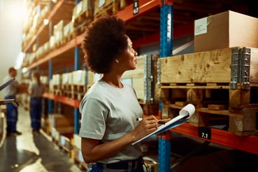 african-american-worker-writing-inventory-list-while-checking-stock-storage-room